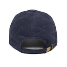 Back view of a navy blue corduroy baseball cap with an adjustable gold metal buckle strap.