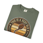 Olive green t-shirt with a vintage-style graphic of a coffee bean shaped like a sperm cell.
