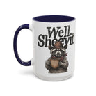 White ceramic mug with a blue handle and rim featuring a raccoon in a cowboy hat holding a mug.