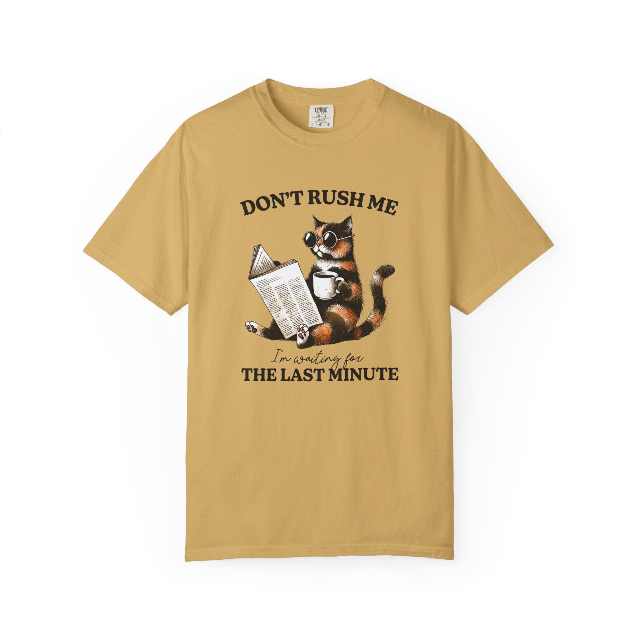 A mustard yellow cotton t-shirt featuring a graphic of a cat wearing sunglasses reading a book.