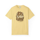 A light yellow t-shirt featuring a distressed retro graphic that says Be Like Coffee.