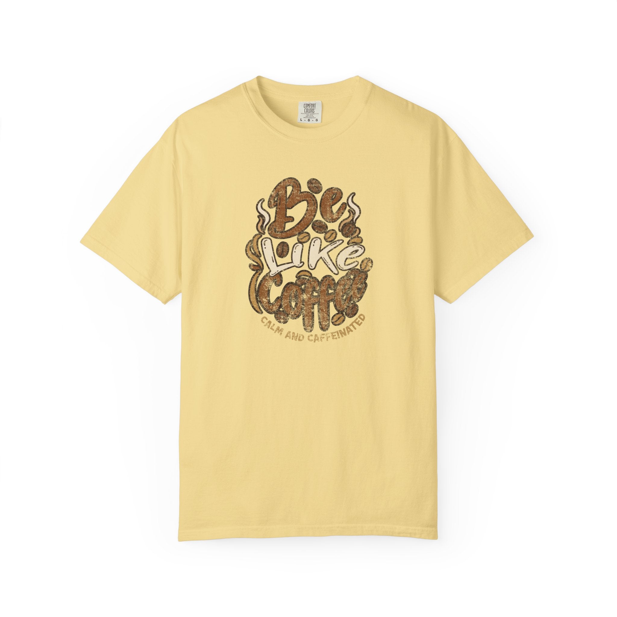 A light yellow t-shirt featuring a distressed retro graphic that says Be Like Coffee.