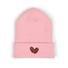 A pink cuffed beanie with two embroidered coffee beans on the cuff.