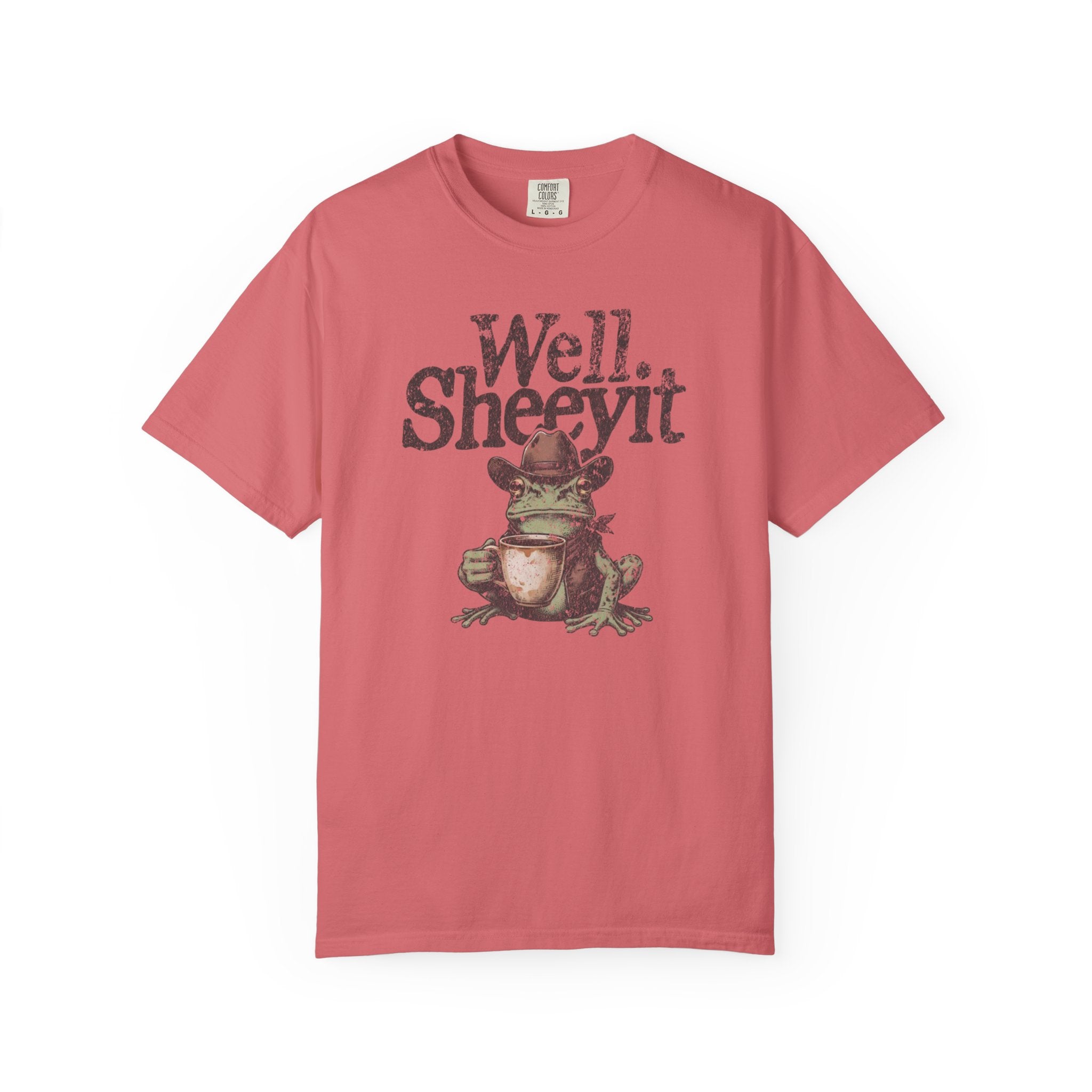 A coral-colored unisex cotton t-shirt featuring a distressed graphic of a cowboy frog with coffee.
