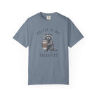 Blue unisex cotton t-shirt featuring a raccoon holding a coffee cup with a skull and crossbones.