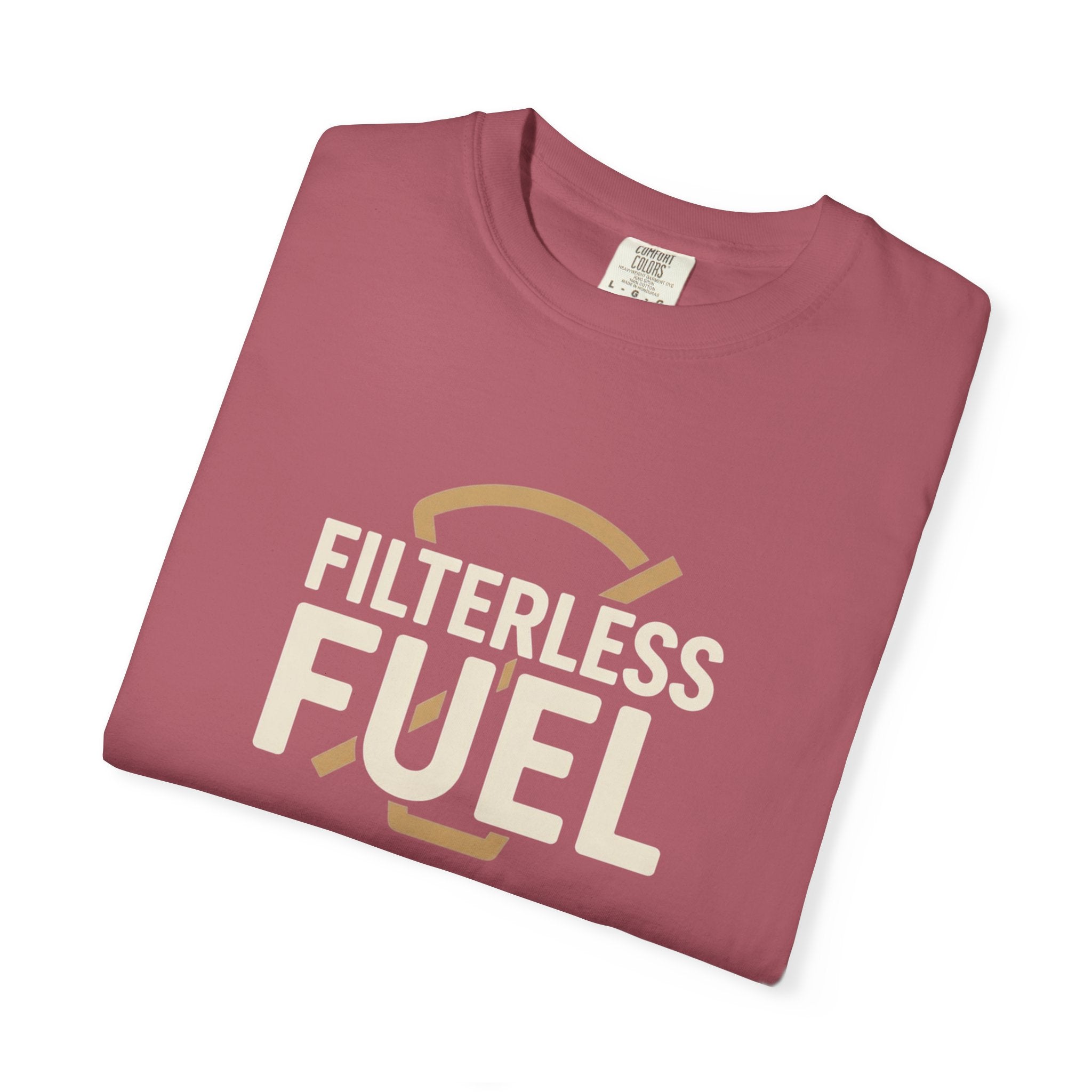 A folded dusty rose t-shirt featuring the text Filterless Fuel in cream and tan.