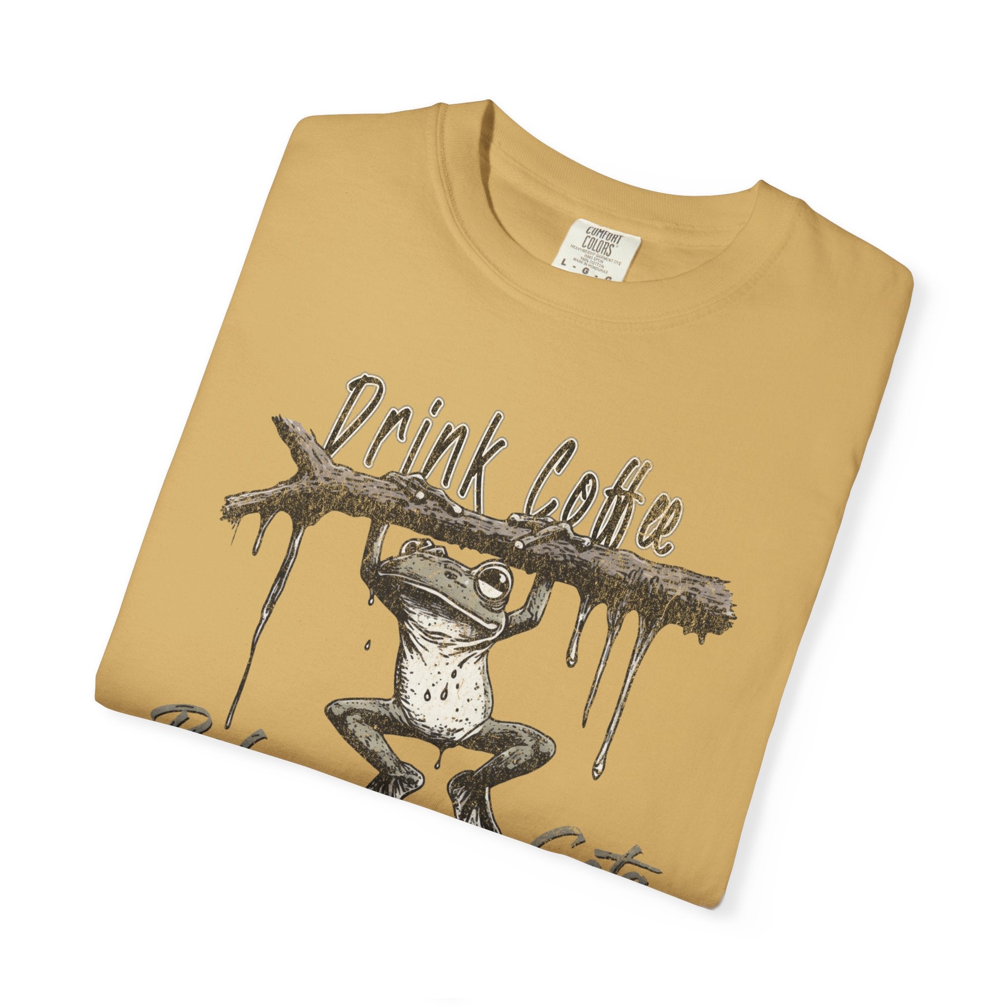Mustard yellow unisex t-shirt featuring a graphic of a frog hanging from a branch with coffee text.