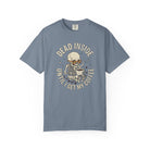 Blue t-shirt featuring a skeleton wearing sunglasses and holding a steaming coffee mug.