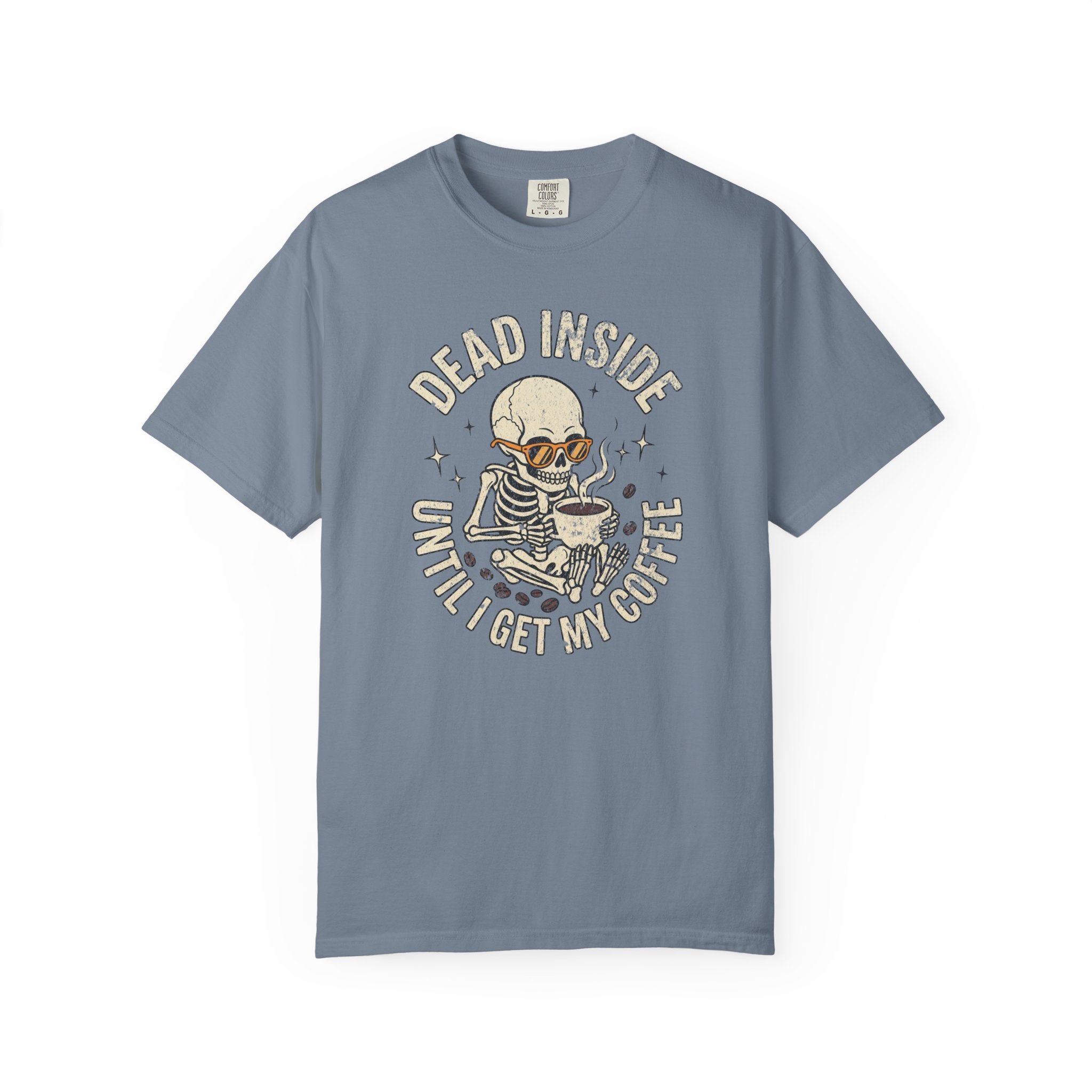 Blue t-shirt featuring a skeleton wearing sunglasses and holding a steaming coffee mug.