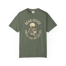 Olive green t-shirt featuring a skeleton wearing sunglasses and holding a steaming coffee mug.