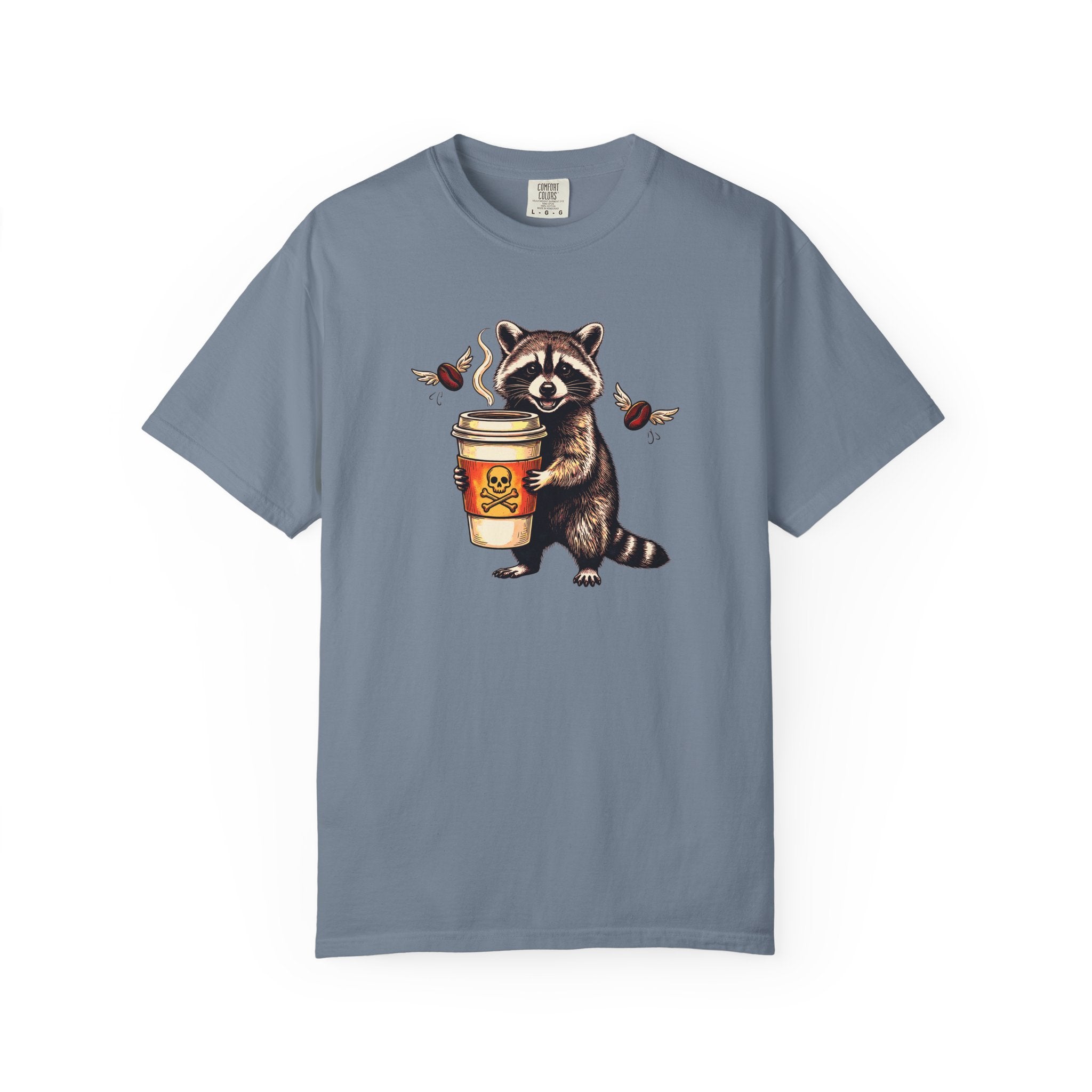 Blue-grey Comfort Colors unisex t-shirt featuring a raccoon holding a coffee cup with a skull logo.