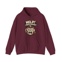 A maroon pullover hoodie featuring a cartoon coffee mug graphic with the text Help I Need Coffee.