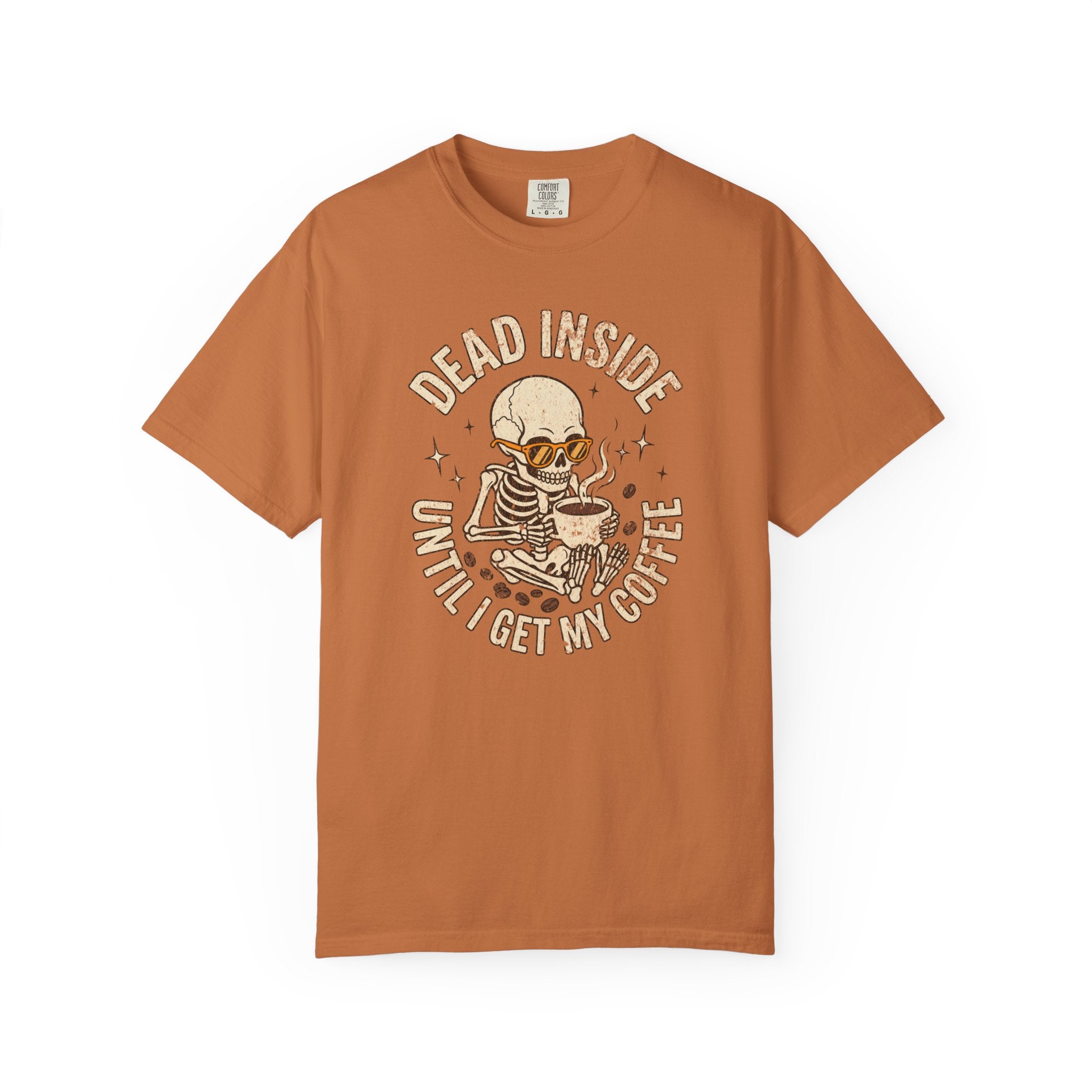 Rust-colored t-shirt with a distressed graphic of a skeleton wearing sunglasses drinking coffee.
