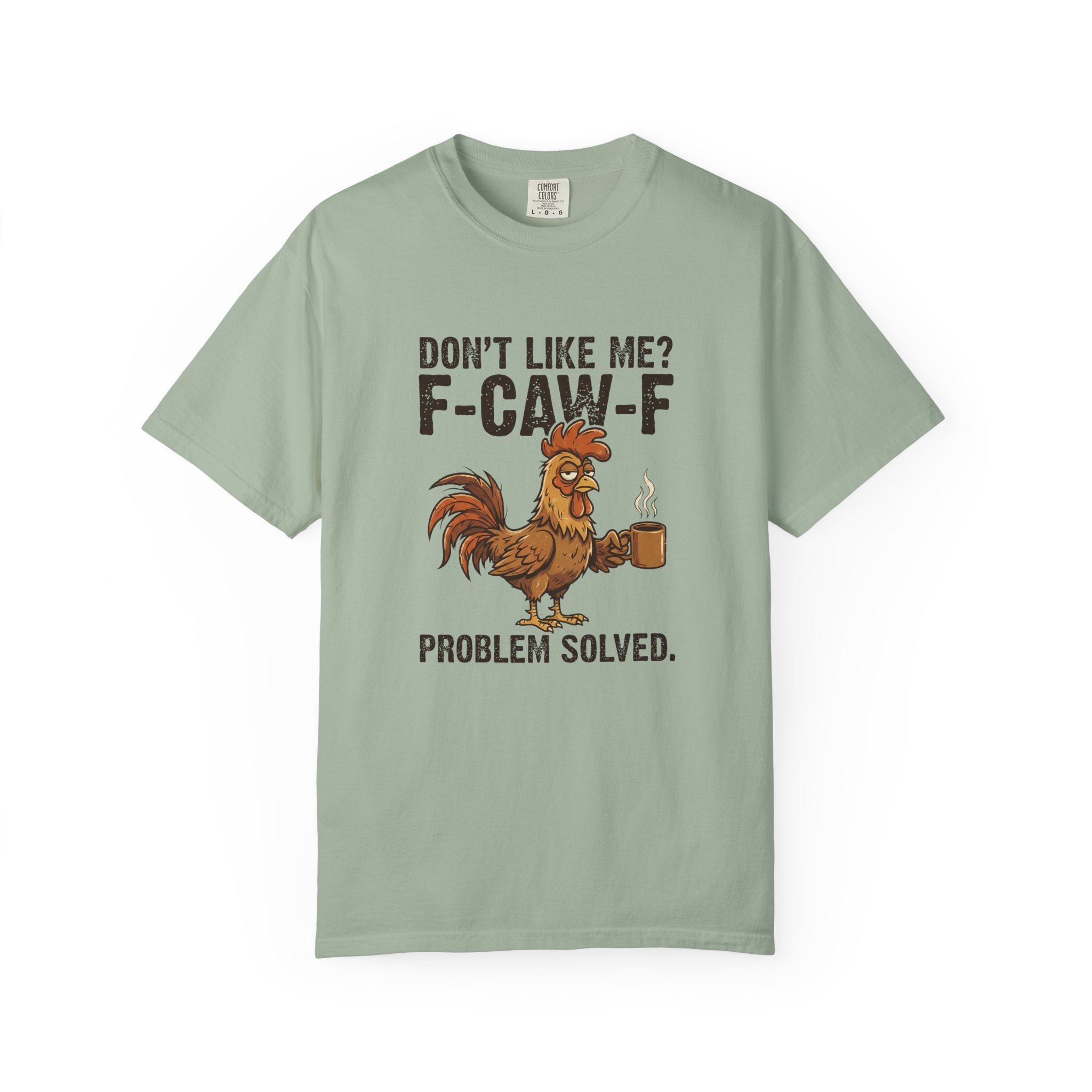 A sage green t-shirt featuring a graphic of a rooster holding a coffee mug with sarcastic text.