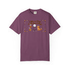 Purple t-shirt with a graphic of a stick figure, a dog, and the text Coffee and Dogs Is My Magic.