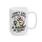 White ceramic coffee mug featuring a grumpy duck holding a mug with text about disliking mornings.