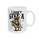 White ceramic coffee mug featuring a cartoon mouse in a cowboy hat riding a donkey.