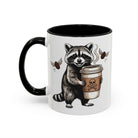 White ceramic mug with a black handle and interior, featuring a raccoon holding a coffee cup.