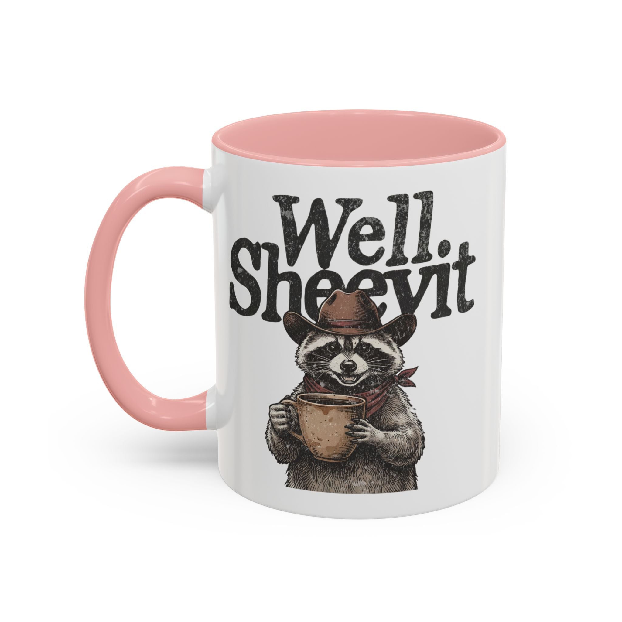 A white ceramic mug with a pink handle and rim, featuring a raccoon in a cowboy hat holding a mug.