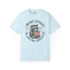Light blue unisex t-shirt featuring a graphic of a raccoon reading a book with sunglasses.