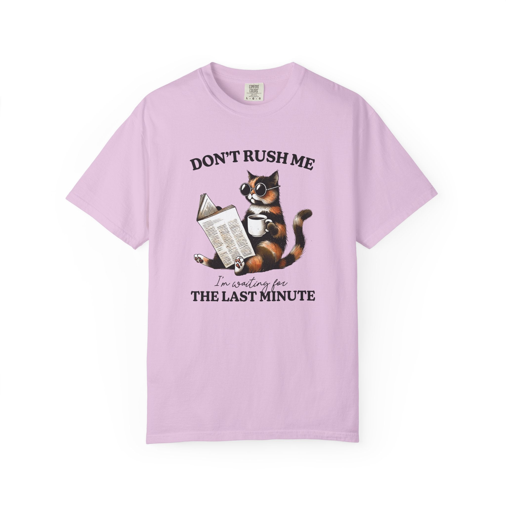 A light purple cotton t-shirt featuring a graphic of a cat wearing sunglasses, reading, and drinking.