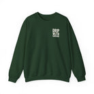 A dark green crewneck sweatshirt featuring the text Drip With Sarcasm on the left chest.