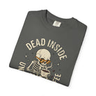 Dark grey t-shirt featuring a skeleton wearing orange sunglasses and holding a cup of coffee.