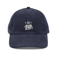 Navy blue corduroy baseball cap with an embroidered white coffee cup and heart logo.
