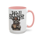 A white ceramic mug with a pink handle and rim, featuring a raccoon wearing a cowboy hat and scarf.