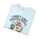 Light blue t-shirt featuring a grumpy duck holding a coffee mug with the text I DON'T LIKE MORNING