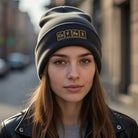A dark gray cuffed beanie with "COFFEE" embroidered in gold periodic table elements.