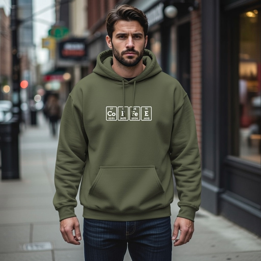A man wears an olive green hoodie featuring a white periodic table graphic that spells out Coffee.