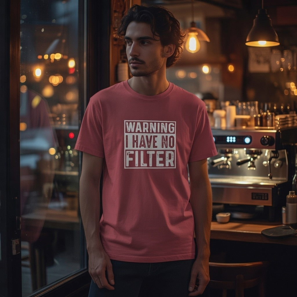 A man wears a pink Comfort Colors t-shirt with a white Warning I Have No Filter graphic.