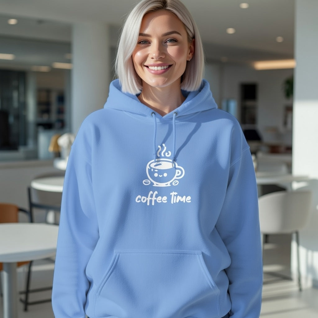 A woman smiles in a light blue hoodie featuring a white coffee cup graphic and coffee time text.