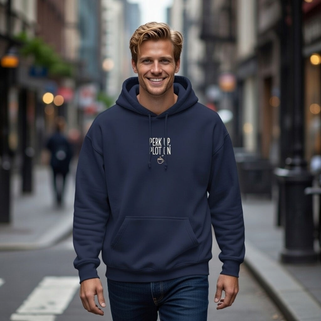 A man wearing a navy blue Perk Up Plot On hoodie with a coffee cup graphic on a city street.