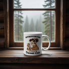 White ceramic mug with a woman holding a cat and the text Introverted But Willing To Discuss Cats.