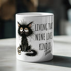 White ceramic mug featuring a scruffy, tired black cat and the text Living That Nine Lives Kind of Tired.