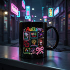 Black ceramic mug with colorful Autism awareness graphics, icons, and text on a city street ledge.
