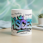 White ceramic mug featuring a colorful graffiti-style Pisces design with astrological traits.
