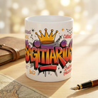 White ceramic mug with a colorful graffiti Sagittarius design and a gold crown on a wooden desk.
