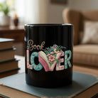 Black ceramic mug featuring the words Book Lover with a floral open book design on a book stack.