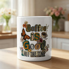 White ceramic mug with vintage floral and butterfly art reading Coffee is Good All The Time.