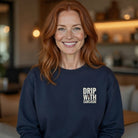 A woman wears a navy blue crewneck sweatshirt featuring the text Drip With Sarcasm on the chest.