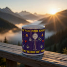 A purple ceramic coffee mug featuring a stick figure holding a controller and coffee cup.