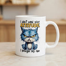 White ceramic mug featuring a grumpy blue cat and the text I don't need your attitude I brought my own.