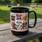Black ceramic mug featuring grumpy cartoon dogs and the text I like the sound you make when you shut up.