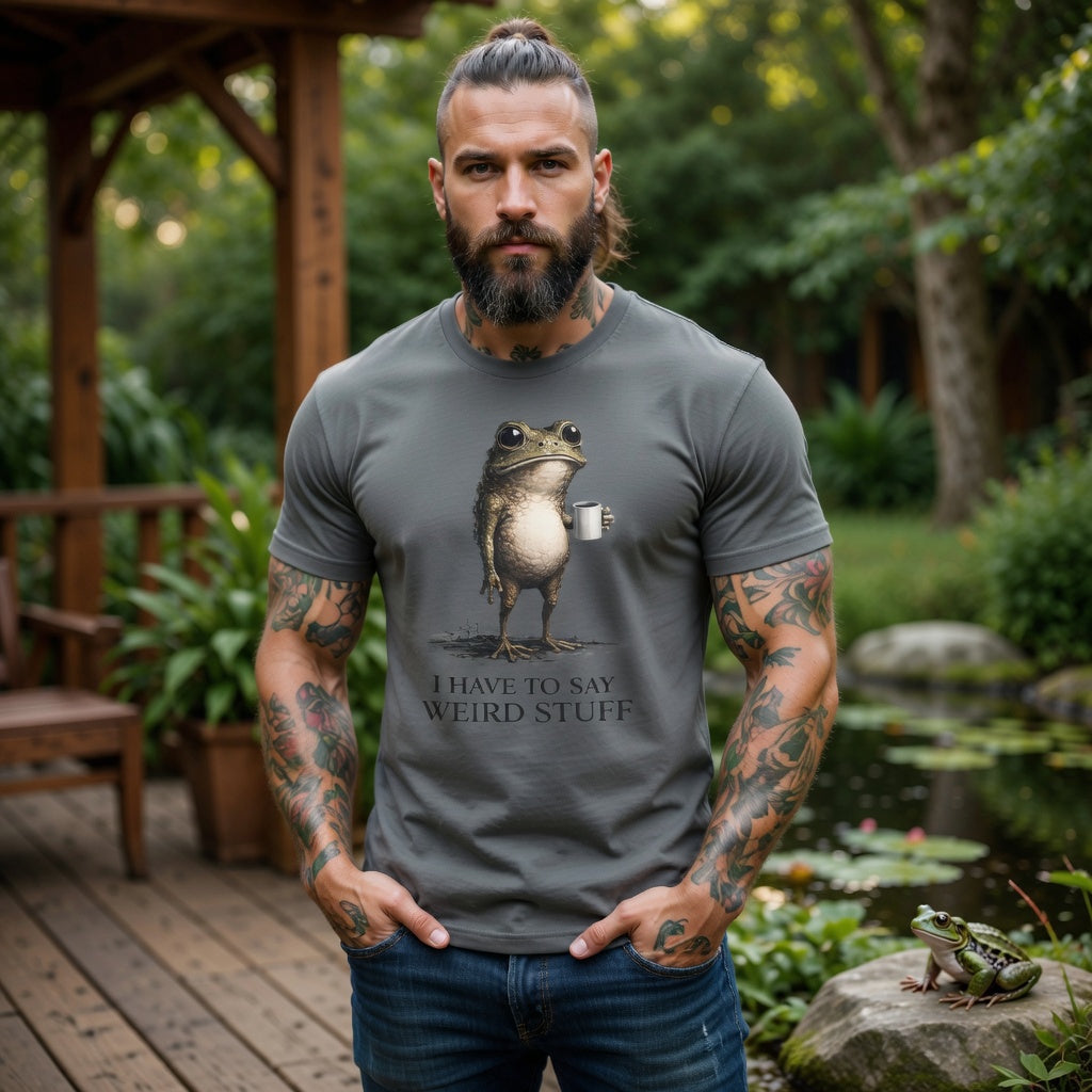 A man wears a grey garment-dyed cotton t-shirt featuring a frog holding coffee and funny text.