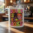 Ceramic mug with a colorful psychedelic design and the text Decaf Is a Joke.