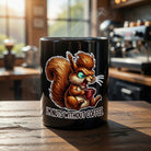 Black ceramic mug featuring a cartoon squirrel and the text I'm Nuts Without Coffee.