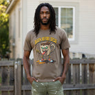 Man wearing a brown t-shirt with a graphic of a zombie coffee mug and the text Death Before Decaf.